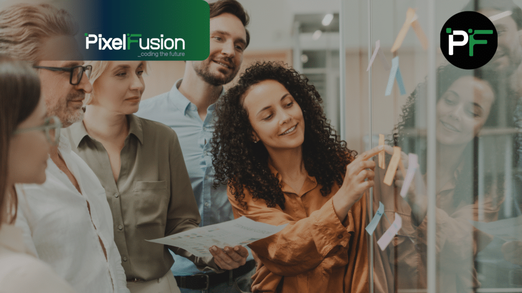 Pixel Fusion Software development team pointing at on-going projects on a whiteboard