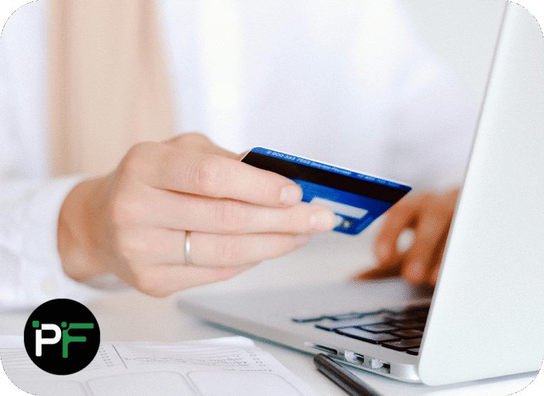 Person holding a credit card in front of a laptop - Image to show eCommerce software development