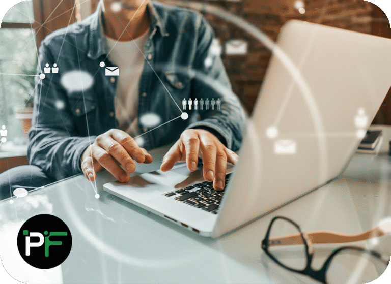 Person working on laptop overlaid with communication symbols to represent IT solutions and software development - 1000x728px