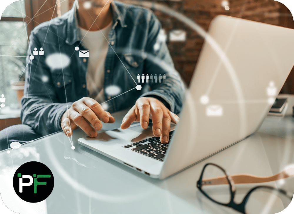 Person working on laptop overlaid with communication symbols to represent IT solutions and software development - 1000x728px