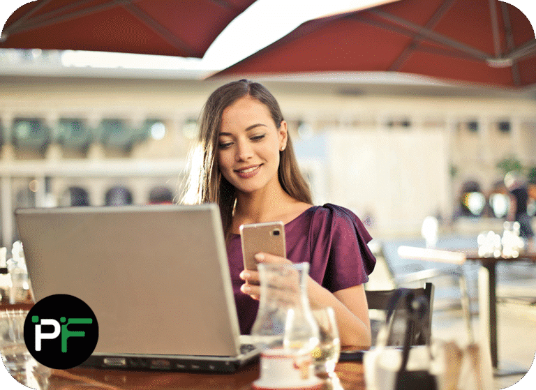 A happy user reviewing data on a laptop, showcasing the seamless integration and productivity benefits of Power Apps Solutions