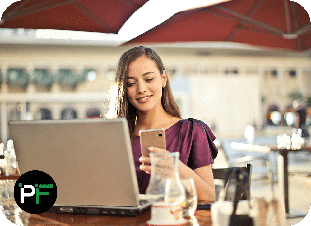 A happy user reviewing data on a laptop, showcasing the seamless integration and productivity benefits of Power Apps Solutions