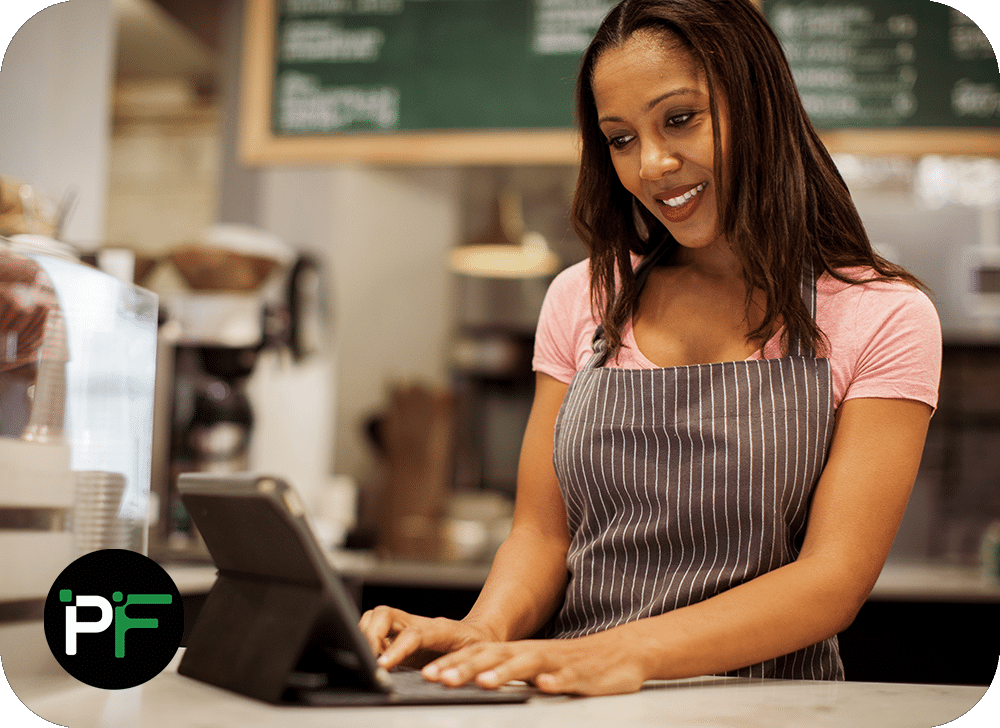 Coffee shop worker at the tills using bespoke retail and POS software