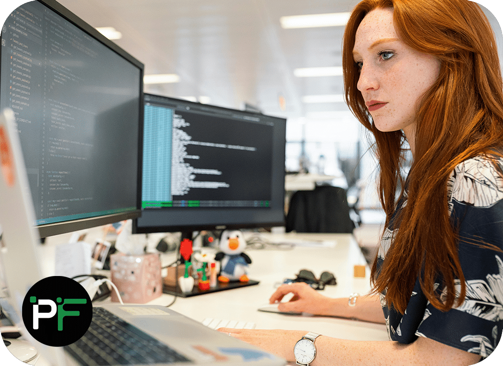 Developer working on a dual monitor setup representing Pixel Fusions software consulting expertise